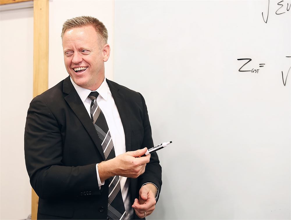 A Pentara statistician presenting informally at the whiteboard, marker in hand